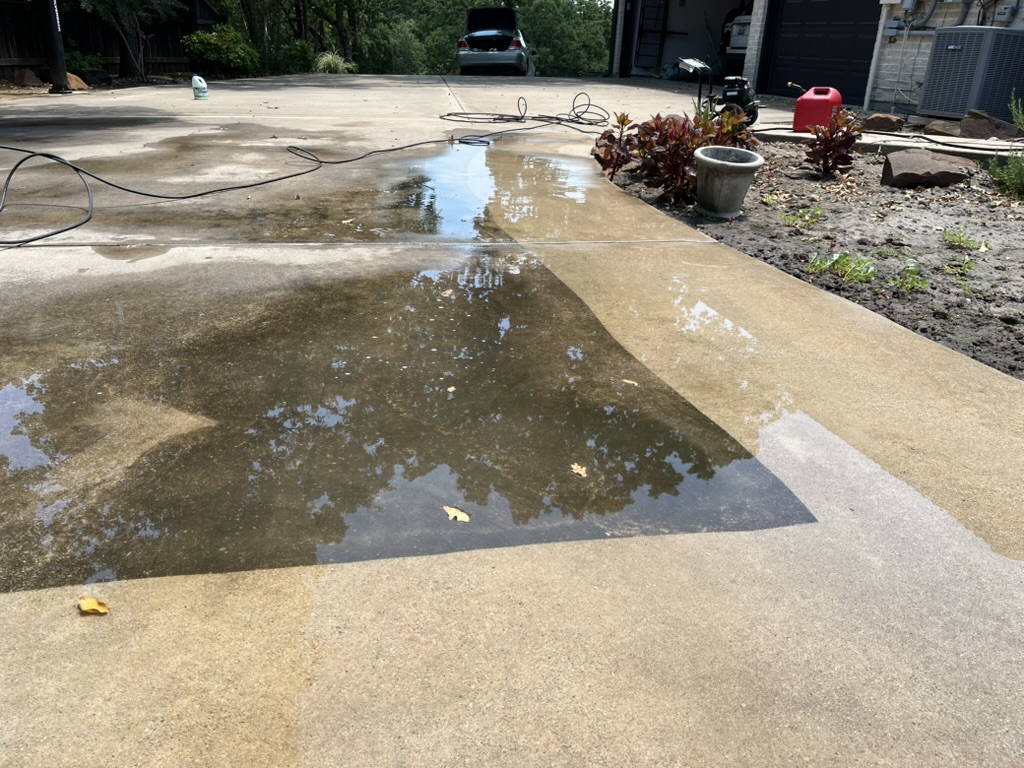 Driveway being pressure washed clean